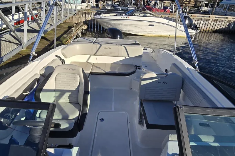 Slide: The Image of 2023 Sea Ray SPX 210 Outboard boat interior at marina, featuring spacious seating and modern design. - 18