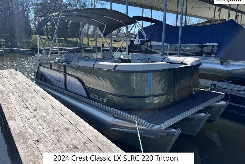 The Image of 2024 Crest Classic LX 220 SLRC pontoon boat docked at marina. - 0