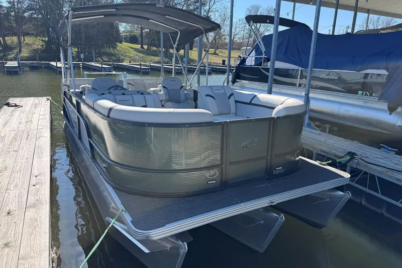 Slide: The Image of 2024 Crest Classic LX 220 SLRC pontoon boat docked at marina. - 10