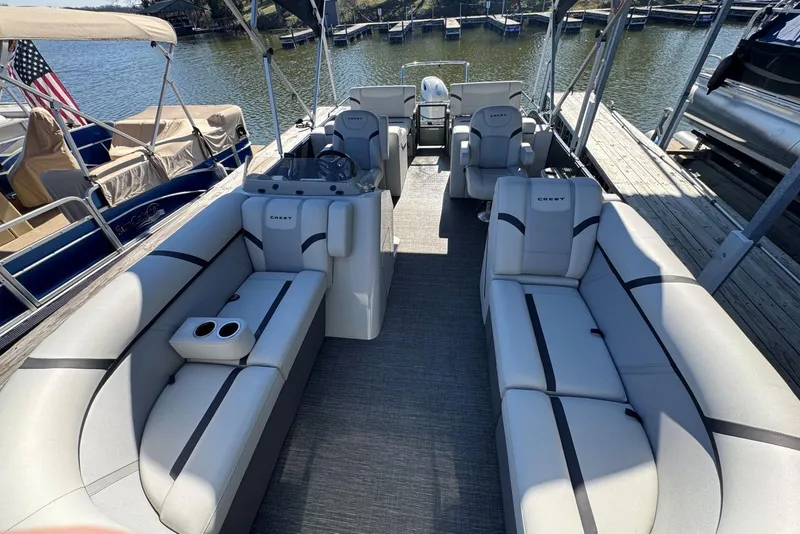 Slide: The Image of 2024 Crest Classic LX 220 SLRC pontoon boat with spacious seating and modern design. - 17