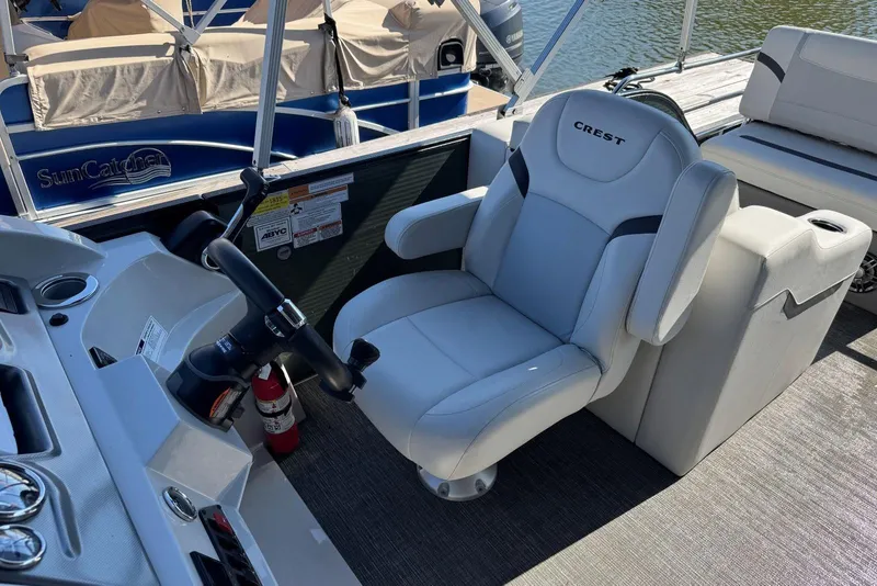Slide: The Image of 2024 Crest Classic LX 220 SLRC boat helm with comfortable captain's chair and steering wheel. - 21