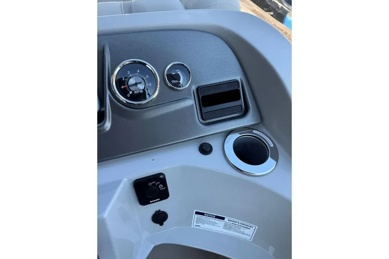 Slide: The Image of 2024 Crest Classic LX 220 SLRC dashboard with RPM gauge and controls. - 25