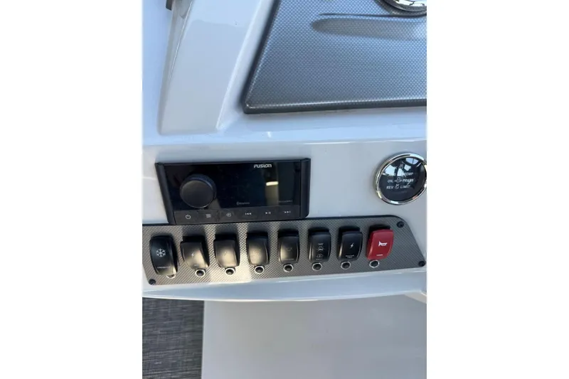 Slide: The Image of Control panel of 2024 Crest Classic LX 220 SLRC boat with switches and gauges. - 26