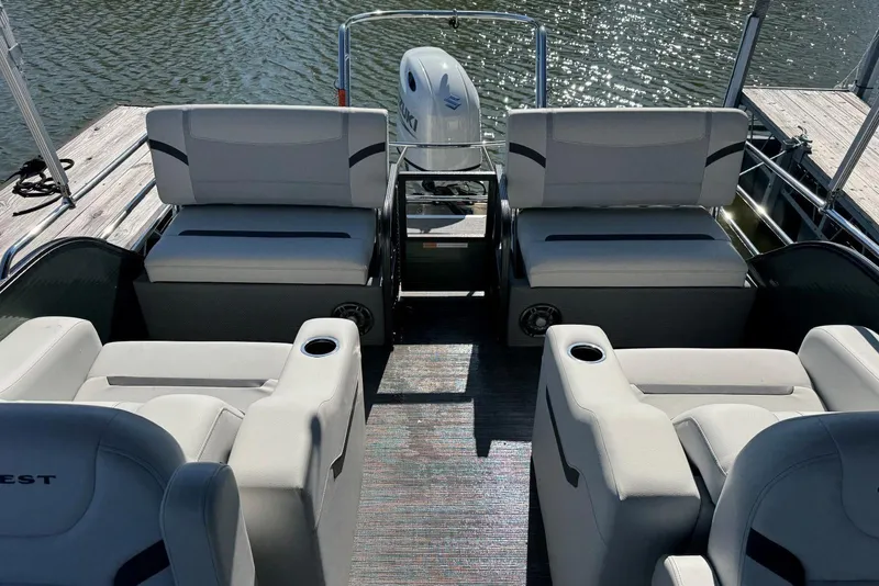 Slide: The Image of 2024 Crest Classic LX 220 SLRC pontoon boat interior with comfortable seating and water view. - 30
