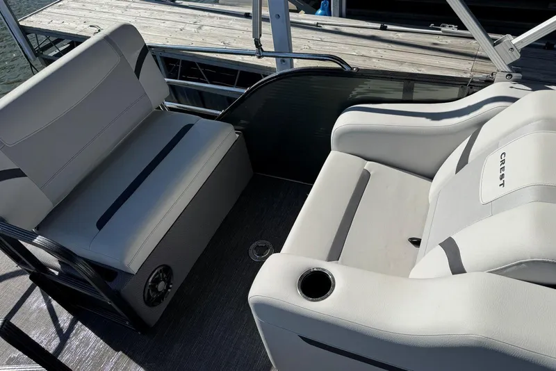 Slide: The Image of 2024 Crest Classic LX 220 SLRC boat interior with comfortable seating and cup holders. - 36