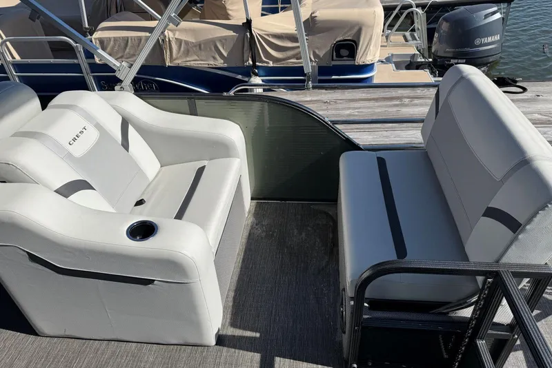 Slide: The Image of 2024 Crest Classic LX 220 SLRC boat interior with comfortable seating and cup holder. - 37