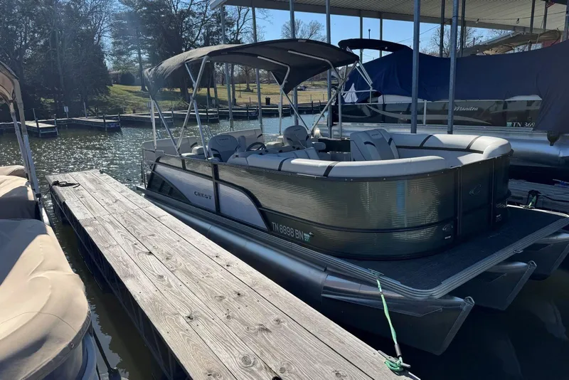 Slide: The Image of 2024 Crest Classic LX 220 SLRC pontoon boat docked on a sunny day. - 4