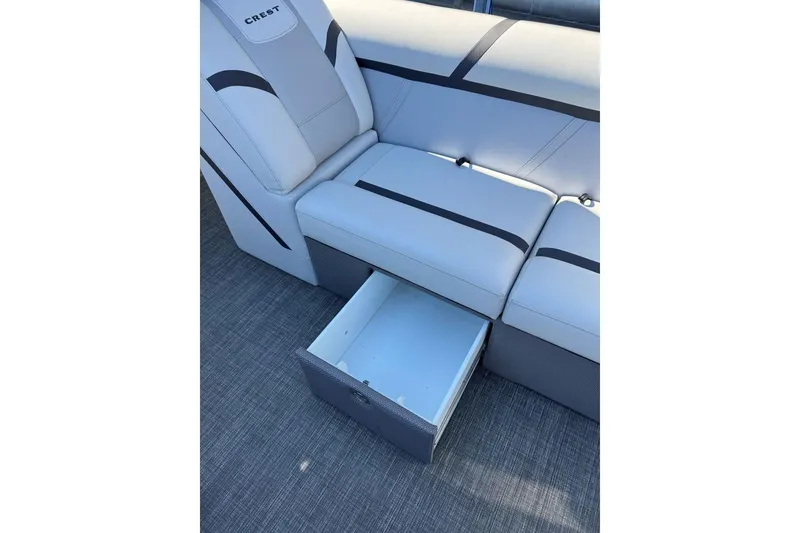 Slide: The Image of 2024 Crest Classic LX 220 SLRC boat seat with storage drawer open. - 41