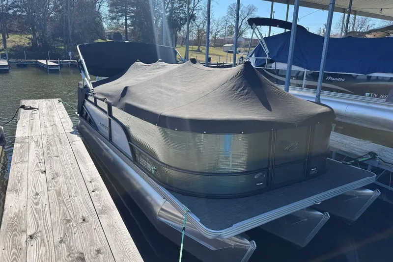 Slide: The Image of 2024 Crest Classic LX 220 SLRC pontoon boat docked with cover on. - 42