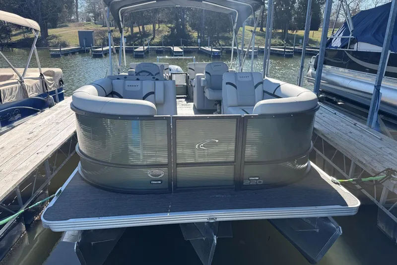 Slide: The Image of 2024 Crest Classic LX 220 SLRC pontoon boat docked on a sunny day. - 6