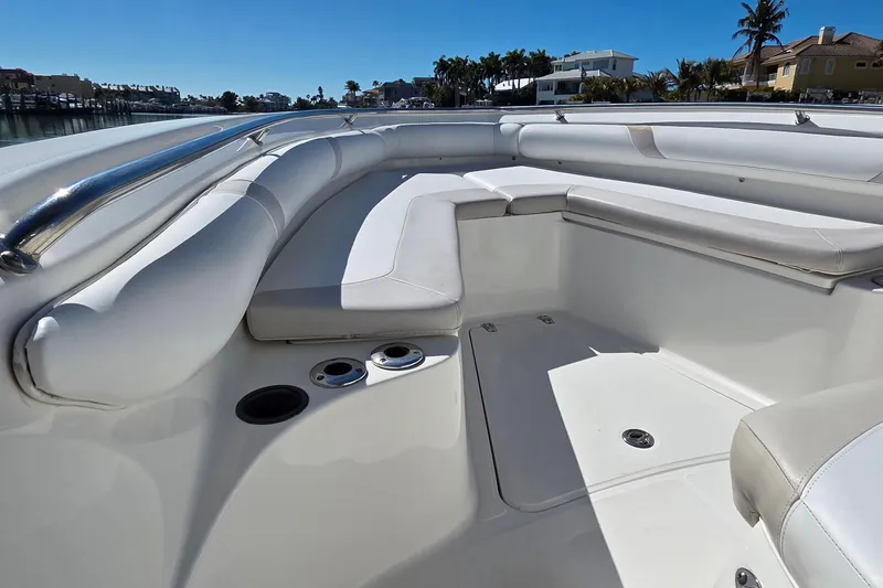 Slide: The Image of 2006 Boston Whaler 270 Outrage boat interior with white cushioned seating and cup holders. - 10