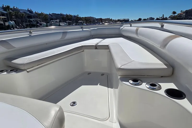 Slide: The Image of 2006 Boston Whaler 270 Outrage boat interior with cushioned seating and cup holders. - 12