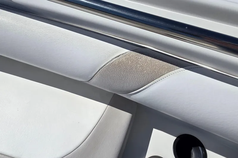 Slide: The Image of 2006 Boston Whaler 270 Outrage interior detail with white upholstery and stainless steel railing. - 13