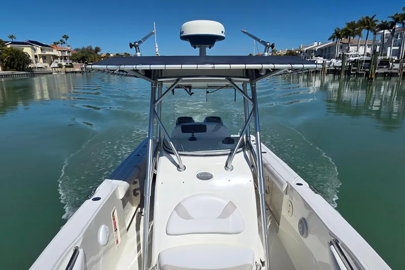 Slide: The Image of 2006 Boston Whaler 270 Outrage cruising in a serene marina with clear blue water. - 16