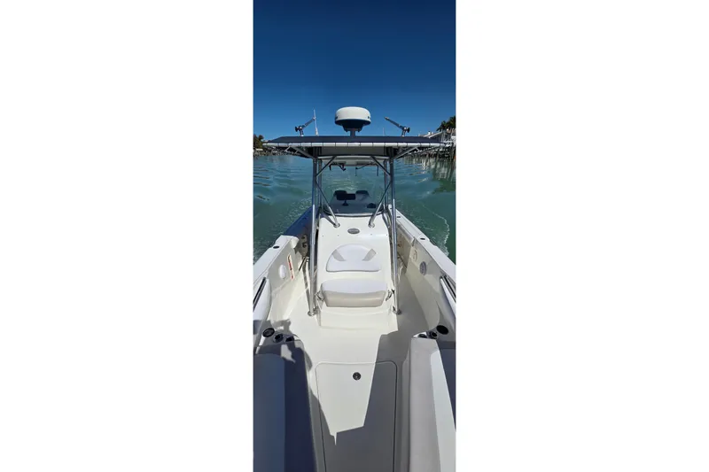 Slide: The Image of 2006 Boston Whaler 270 Outrage boat on calm water, clear sky background. - 17