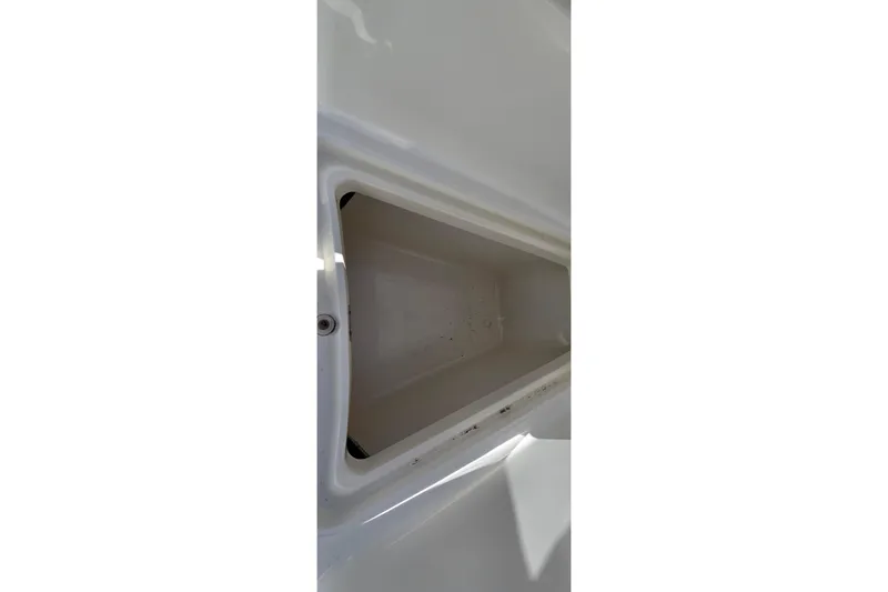 Slide: The Image of Storage compartment of a 2006 Boston Whaler 270 Outrage boat, open and empty. - 18