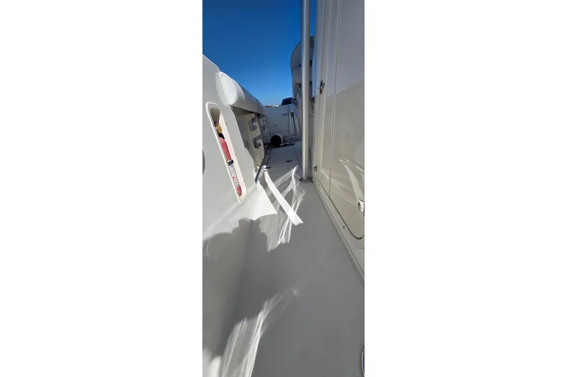 Slide: The Image of 2006 Boston Whaler 270 Outrage boat deck with clear blue sky. - 19