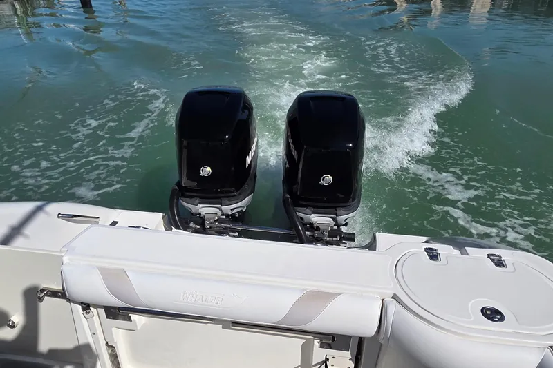 Slide: The Image of 2006 Boston Whaler 270 Outrage with dual outboard motors on water. - 21