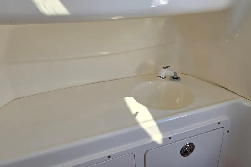 Slide: The Image of 2006 Boston Whaler 270 Outrage boat interior sink and storage area. - 22