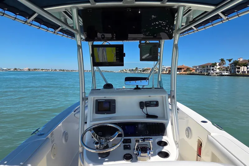 Slide: The Image of 2006 Boston Whaler 270 Outrage boat dashboard with navigation equipment on calm waters. - 29