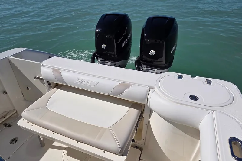 Slide: The Image of 2006 Boston Whaler 270 Outrage boat with dual Mercury engines on open water. - 3