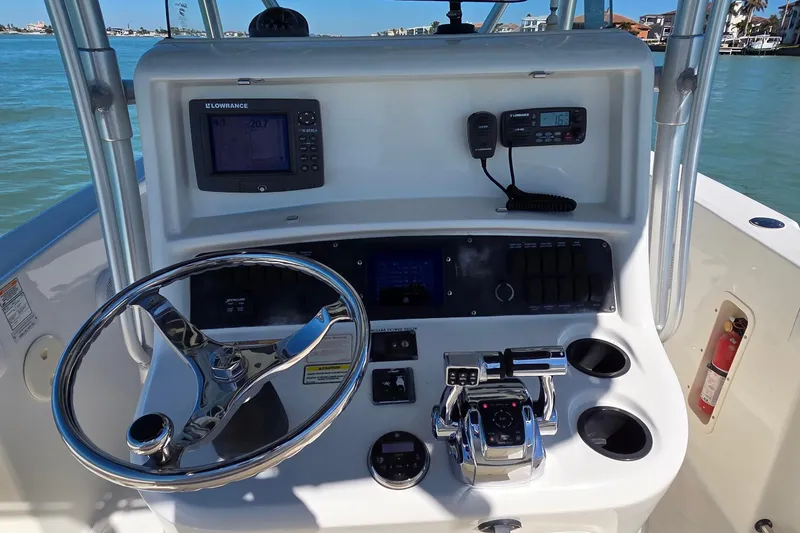 Slide: The Image of 2006 Boston Whaler 270 Outrage boat dashboard with steering wheel and navigation equipment. - 30