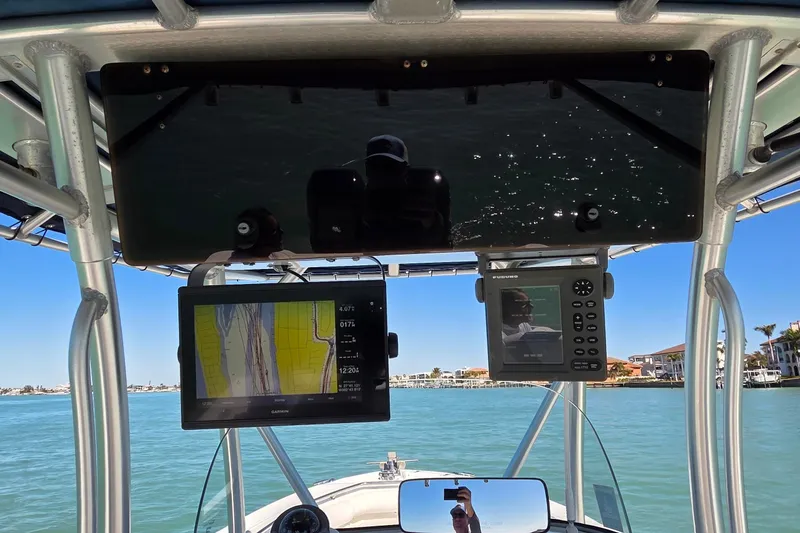 Slide: The Image of 2006 Boston Whaler 270 Outrage dashboard with navigation screens on a sunny day. - 31