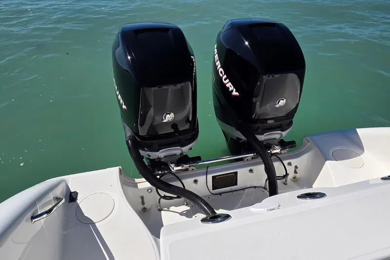 Slide: The Image of 2006 Boston Whaler 270 Outrage with twin Mercury outboard engines on calm water. - 36