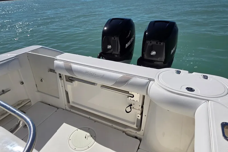 Slide: The Image of 2006 Boston Whaler 270 Outrage boat with dual Mercury engines on calm water. - 39