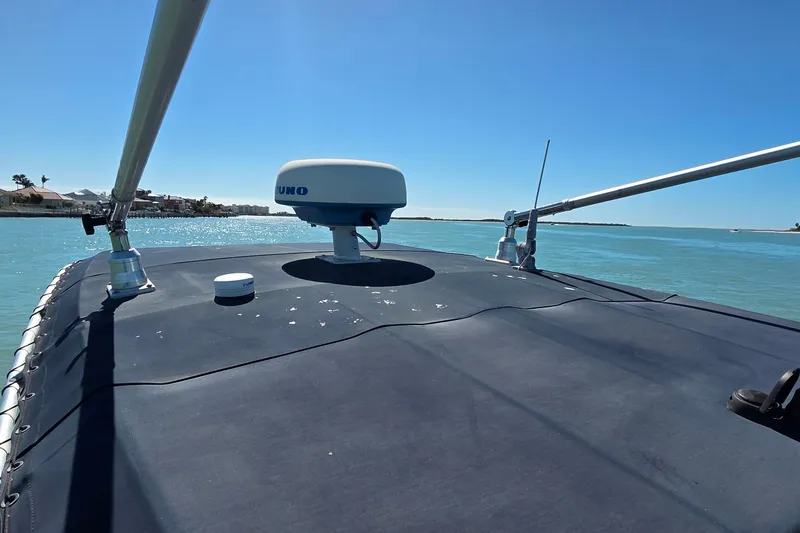 Slide: The Image of 2006 Boston Whaler 270 Outrage boat on calm blue water under clear sky. - 5