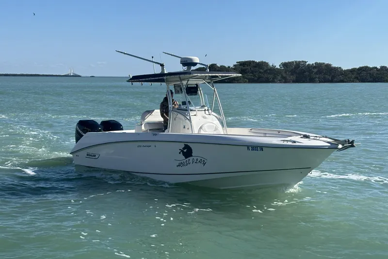 Slide: The Image of 2006 Boston Whaler 270 Outrage boat cruising on calm waters. - 54