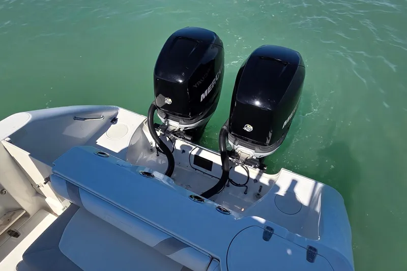 Slide: The Image of 2006 Boston Whaler 270 Outrage with dual Mercury outboard engines on turquoise water. - 6
