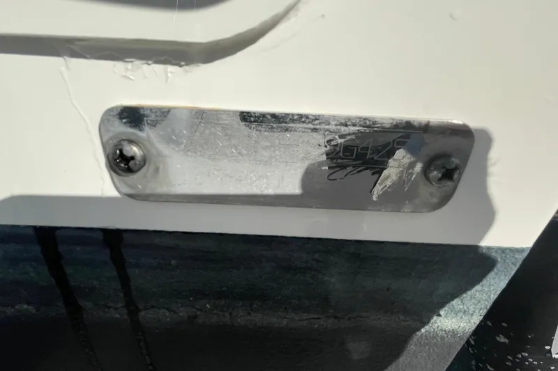 Slide: The Image of 2025 Boston Whaler 280 Outrage nameplate with visible wear and screws. - 16