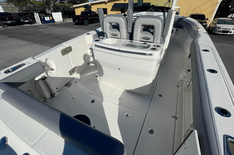 Slide: The Image of 2025 Boston Whaler 280 Outrage boat interior, featuring seating and storage compartments. - 19