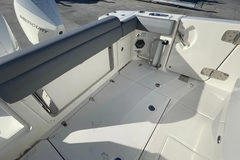 Slide: The Image of 2025 Boston Whaler 280 Outrage boat deck with Mercury engine, featuring sleek design and modern fittings. - 20