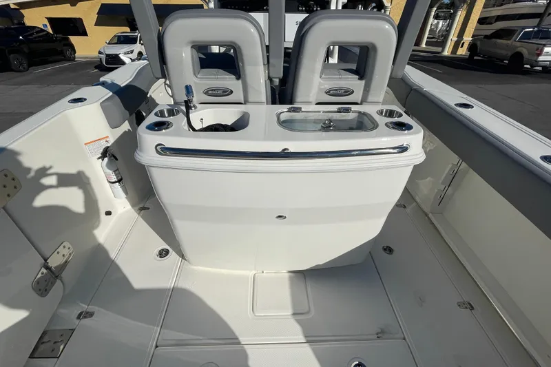 Slide: The Image of 2025 Boston Whaler 280 Outrage boat interior with seating and storage features. - 21