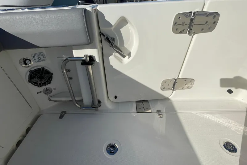 Slide: The Image of 2025 Boston Whaler 280 Outrage boat interior with stainless steel fixtures and speaker. - 24