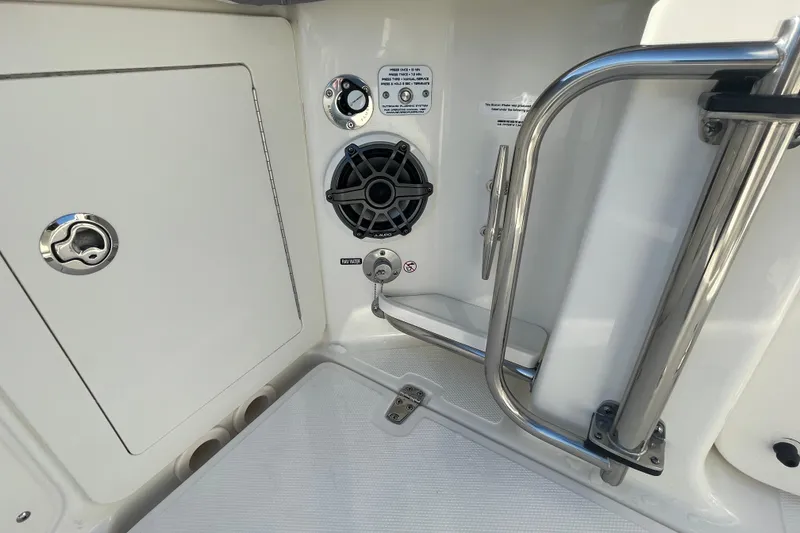 Slide: The Image of 2025 Boston Whaler 280 Outrage boat interior with speaker and stainless steel railing. - 25