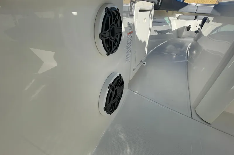 Slide: The Image of 2025 Boston Whaler 280 Outrage interior with dual speakers and sleek design. - 26