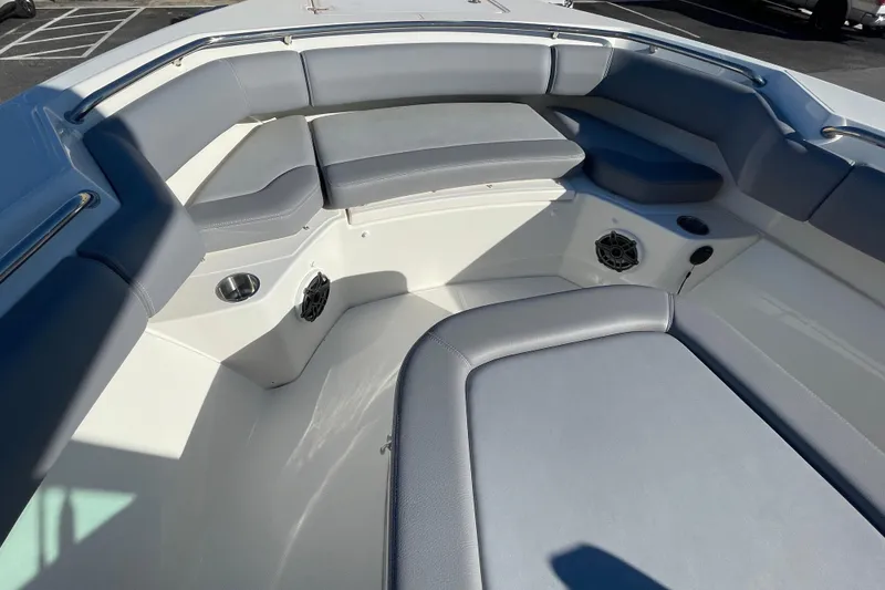 Slide: The Image of 2025 Boston Whaler 280 Outrage boat interior with cushioned seating and cup holders. - 28