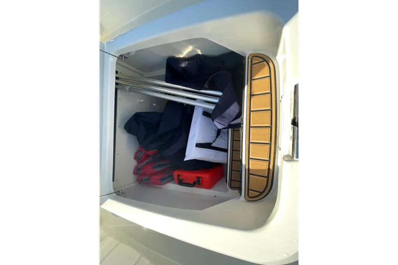 Slide: The Image of Storage compartment of 2025 Boston Whaler 280 Outrage with life jackets and equipment. - 30