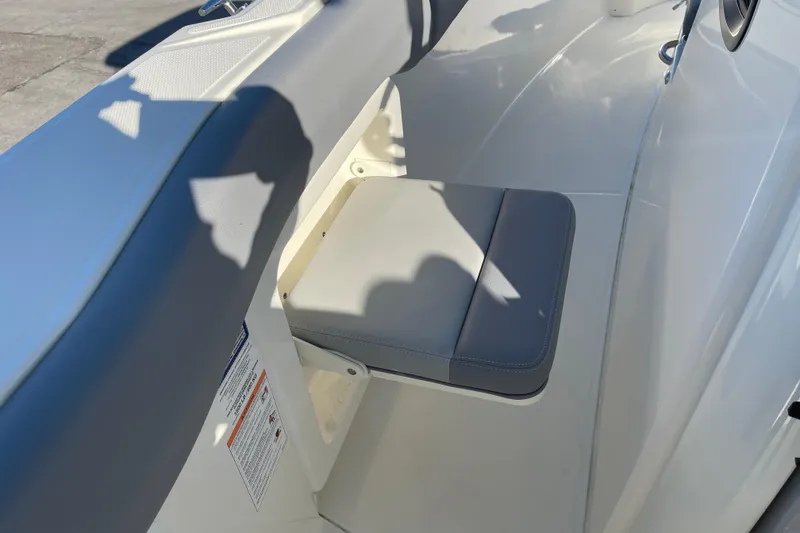 Slide: The Image of 2025 Boston Whaler 280 Outrage boat seat detail with gray cushion and white interior. - 37