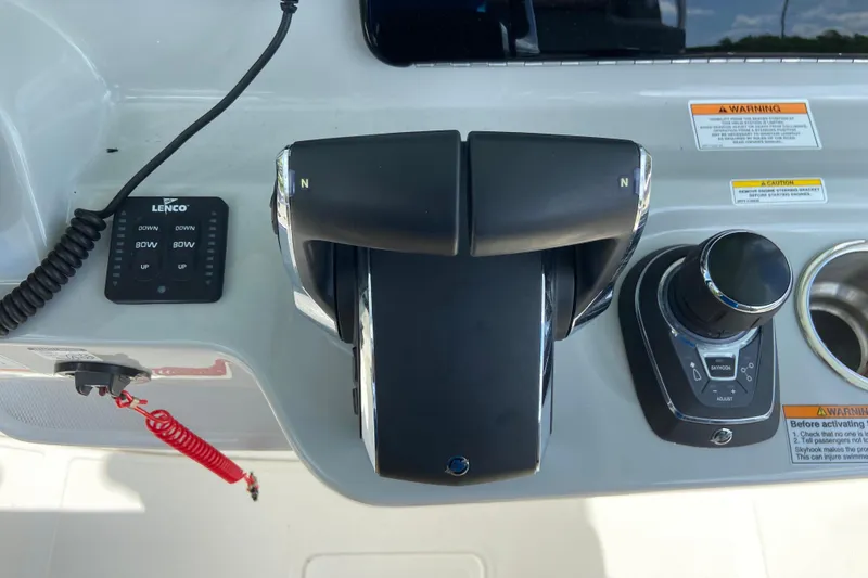 Slide: The Image of Control panel of 2025 Boston Whaler 280 Outrage boat, featuring throttle and joystick controls. - 41
