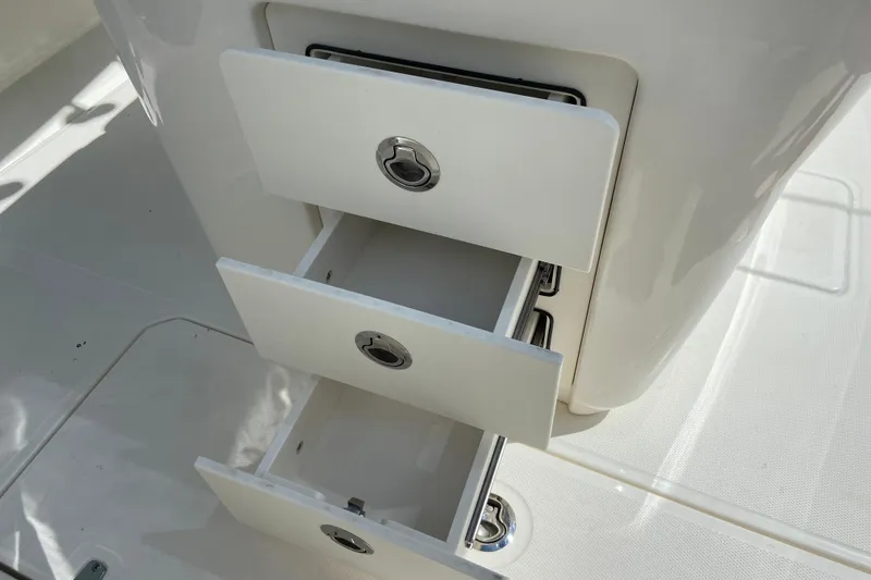 Slide: The Image of Storage drawers on a 2025 Boston Whaler 280 Outrage boat, showcasing sleek design. - 44