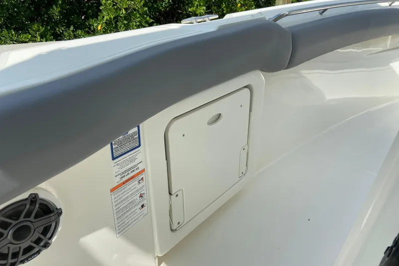 Slide: The Image of 2025 Boston Whaler 280 Outrage interior detail with storage compartment and speaker. - 45