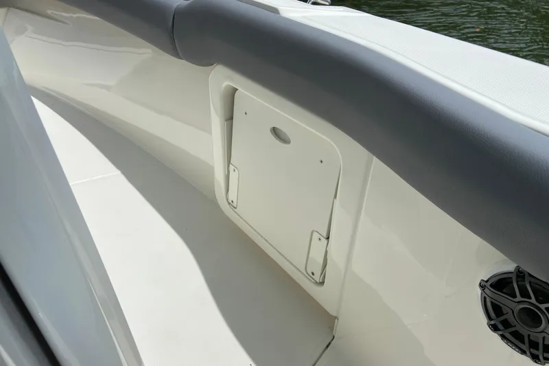 Slide: The Image of 2025 Boston Whaler 280 Outrage interior detail with storage compartment and speaker. - 47