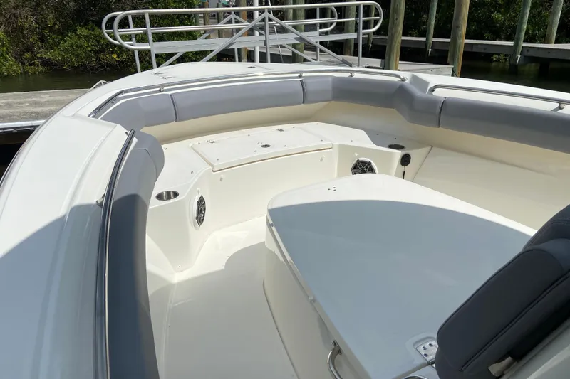 Slide: The Image of 2025 Boston Whaler 280 Outrage boat interior with cushioned seating and storage compartments. - 50