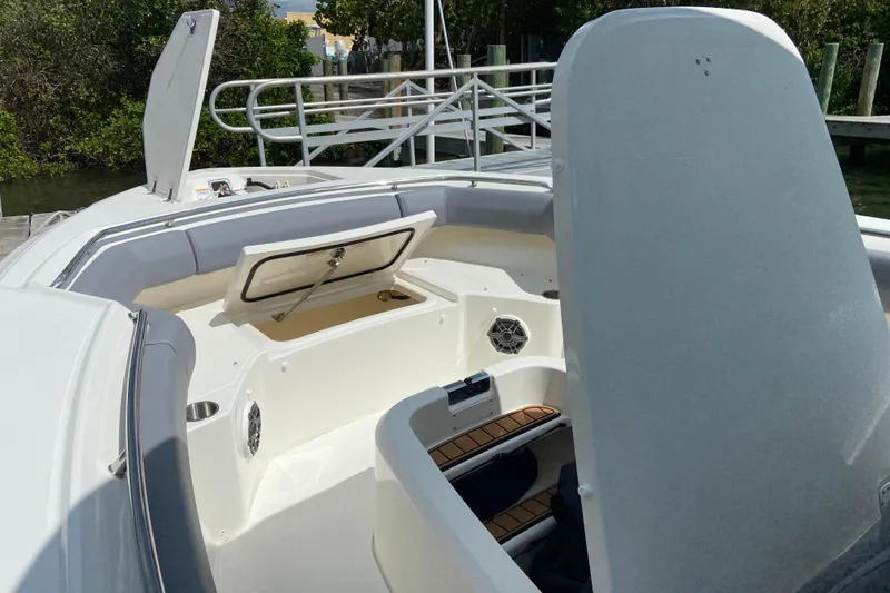 Slide: The Image of 2025 Boston Whaler 280 Outrage boat interior with open storage compartments and seating. - 51