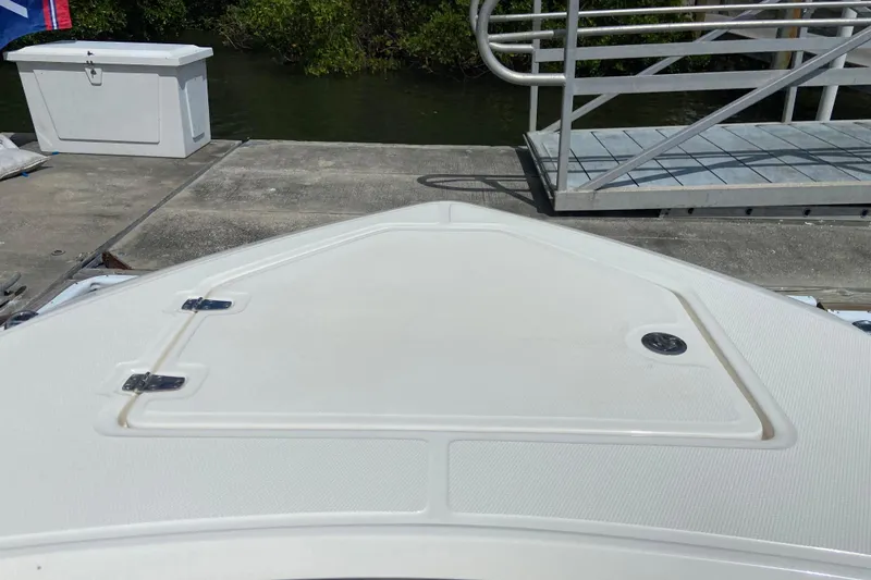 Slide: The Image of Bow of 2025 Boston Whaler 280 Outrage docked, featuring storage hatch and sleek design. - 52