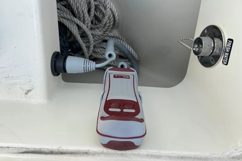 Slide: The Image of Storage compartment on a 2025 Boston Whaler 280 Outrage with rope and fresh water access. - 54